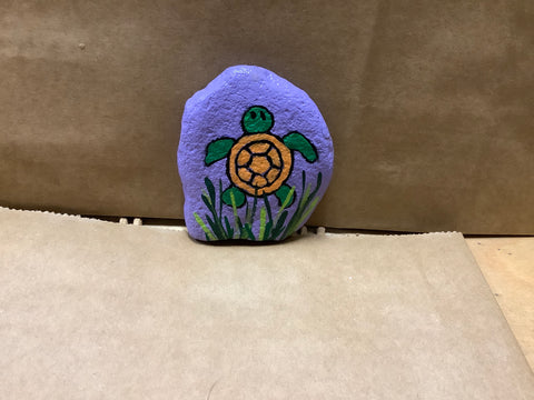 Turtle in grass  hand painted by local artist Cecelia.  Each rock is $3.