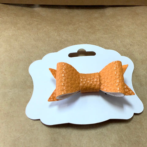 Orange faux leather bow on barrette by Barbie