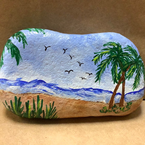 Large rock with beach scene.