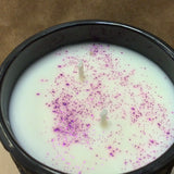 Midnight Blackberry double wick with sparkles in a black reusable container organic soy wax. With purple sparkles.