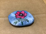Flowered Rock Hand Painted by Local Artist Cecelia.  Each Rock  is $3.