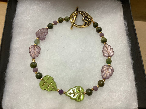 Autumn bracelet with gold findings with green and mauve leaf beads with gold  and green tiny beads.