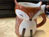 Fox Cup of Cozy Cup by Natural Life.Brown with a small floral design in beige.