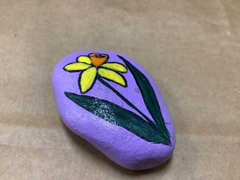 Painted flower on rock by local artist Cecelia
