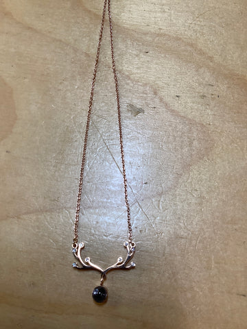 Gold plated over stainless steel with a small stone.
