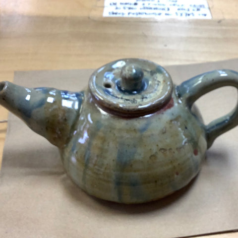 Greenish grey with blues and browns thru it teapot
