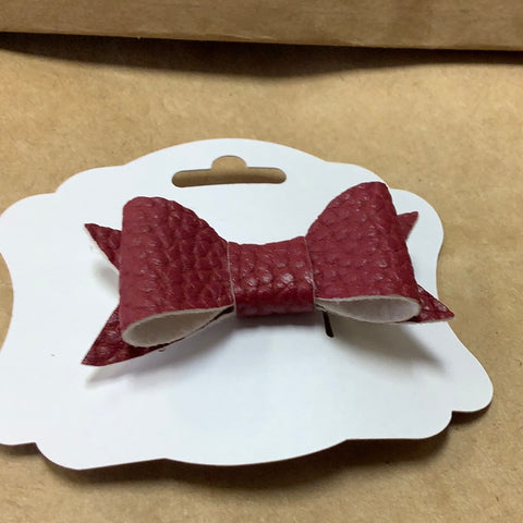 Burgandy faux leather bow on a barrette by Barbie