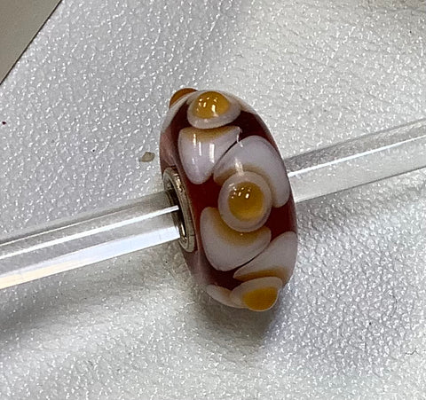 Troll bead amber, white w yellow dots