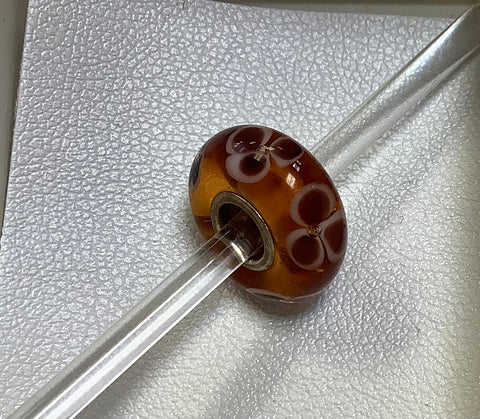 Troll bead amber w/ brown flowers