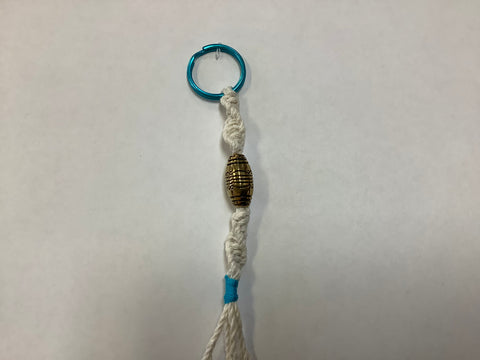 White keychain w/ gold w/ blue ring by Nancy
