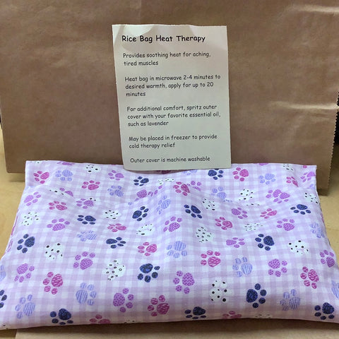 Rice bag heat therapy lavender with different colored paw prints by local artist Ann
